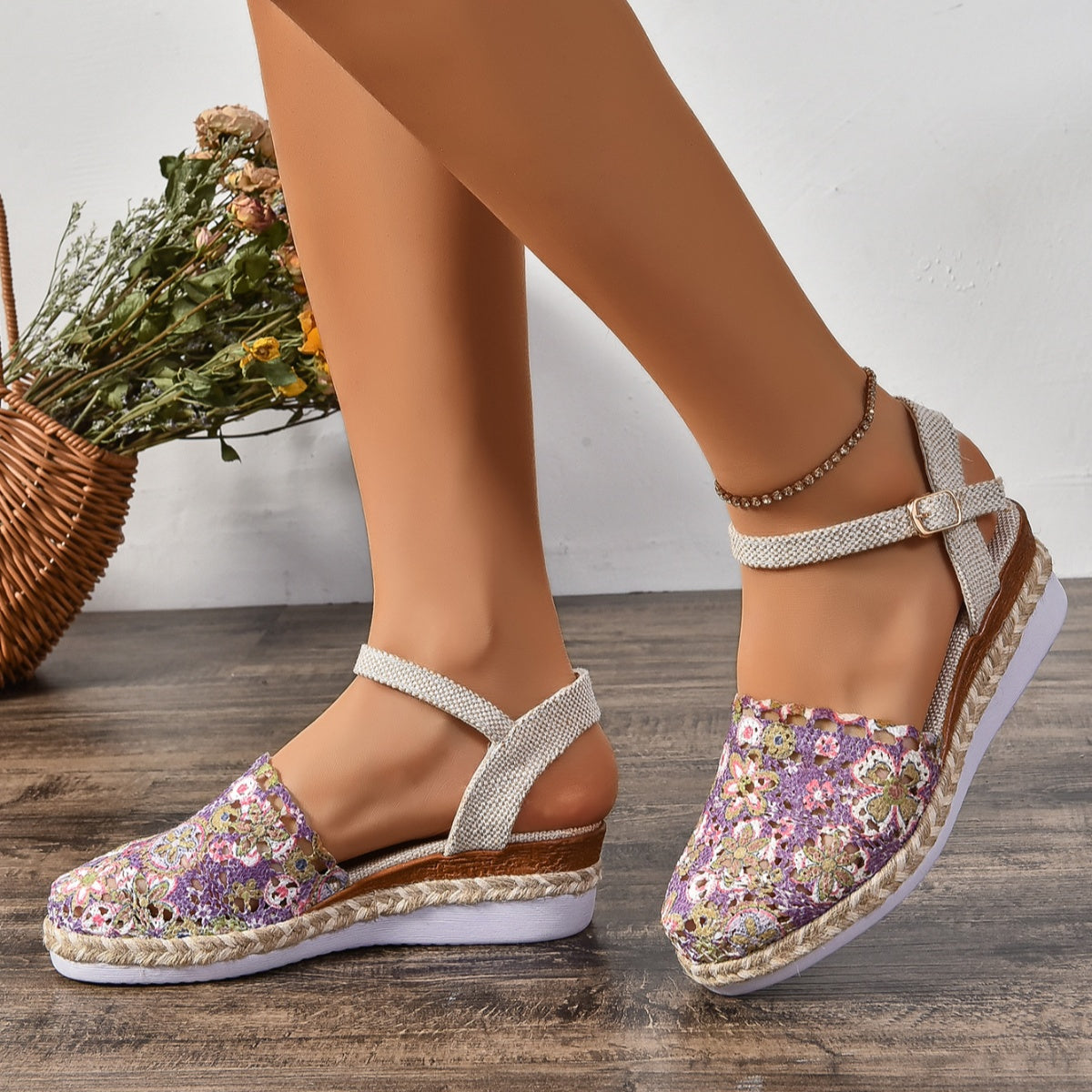 Floral espadrille wedge sandals in purple with adjustable ankle strap and round toe.