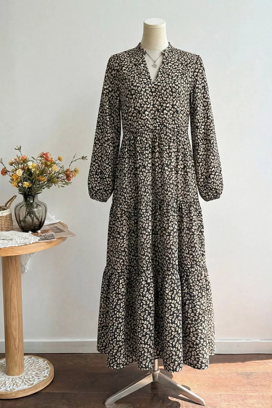 Black animal print midi dress with balloon sleeves and tiered skirt