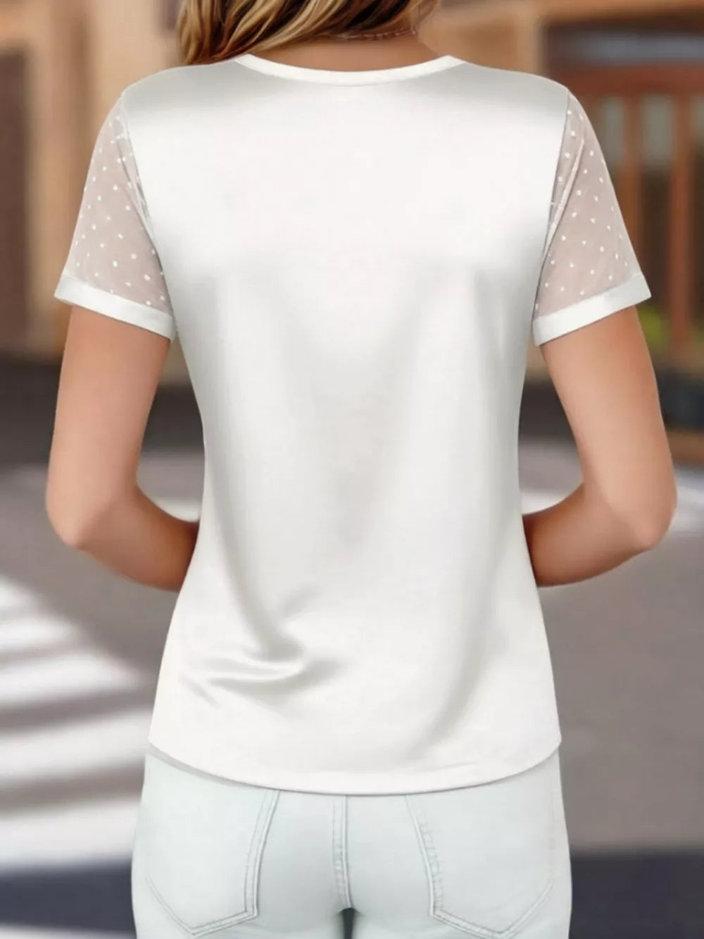 White satin t-shirt with sheer polka dot sleeves and V-neck.