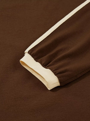 Dark brown long-sleeve t-shirt with cream contrast trim on sleeve and cuff