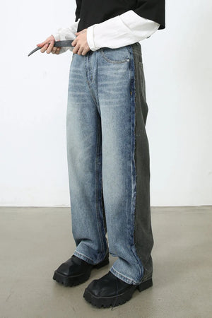 Paneled wide-leg denim trousers in medium wash with contrasting grey denim side panel.