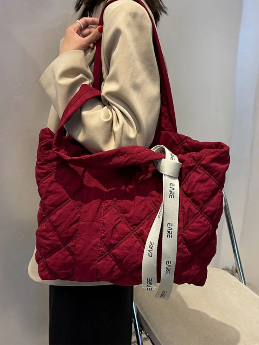 Burgundy diamond quilt nylon tote bag with logo strap detail