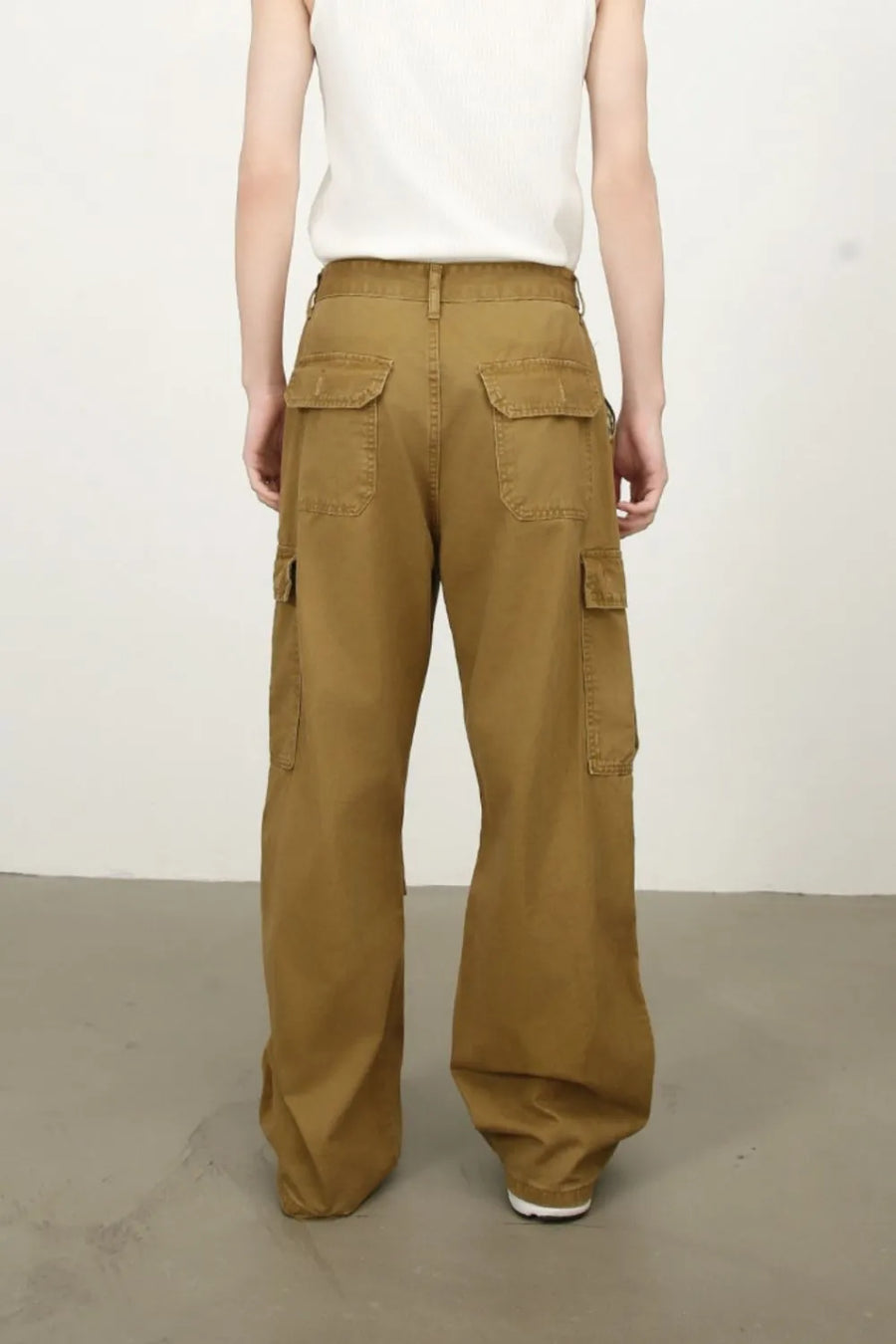 Khaki cargo pants with wide legs and multiple pockets.