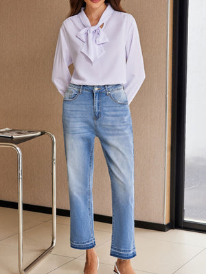 Whiskered wash cropped jeans in light blue denim with frayed hem detail.