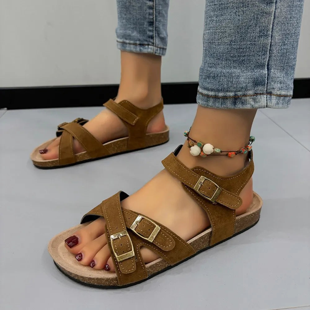 Suede crossover buckle cork sandals in mocha with adjustable straps and a cork footbed.