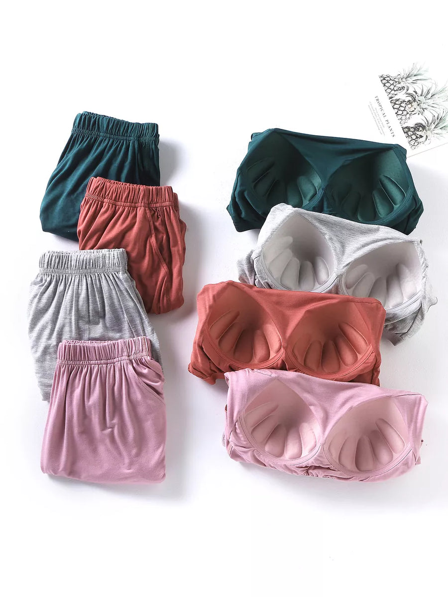 Pajama shorts with elastic waistbands and padded bralettes in various colors.