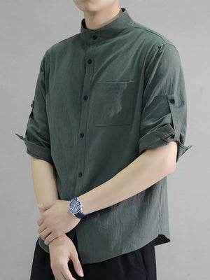 Men's army green cotton shirt with roll-up sleeves and chest pocket.