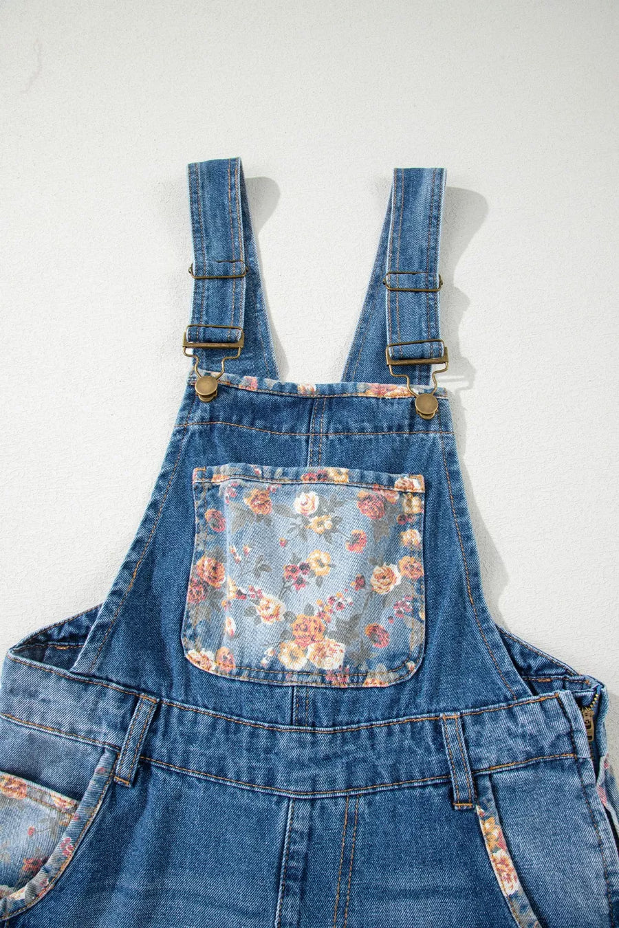 Denim overalls with vintage floral print pocket and trim detail.