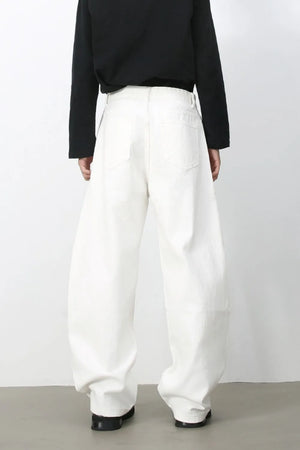 Sculpted white denim balloon trousers with a high waist and wide leg, shown from the back.