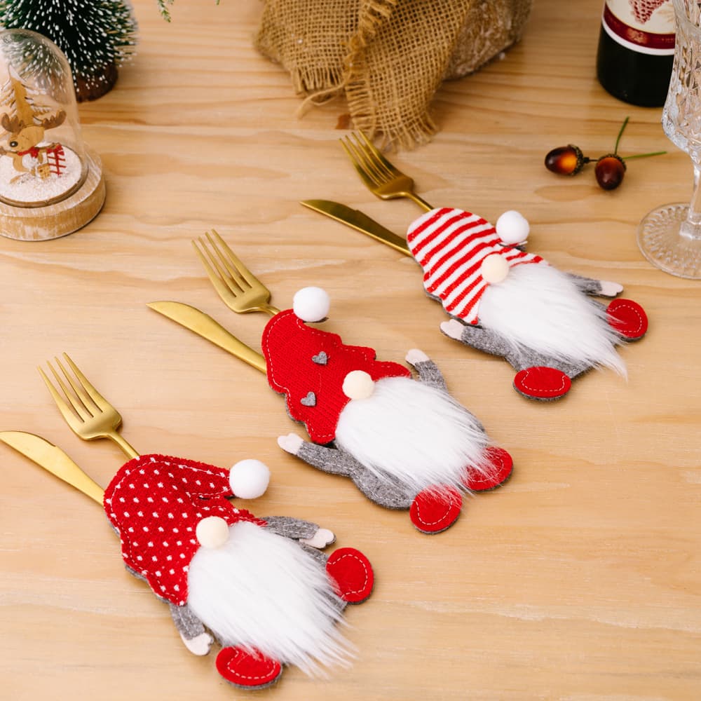 Festive gnome cutlery accoutrements in red and white, with white beards and hats, designed to adorn silverware.