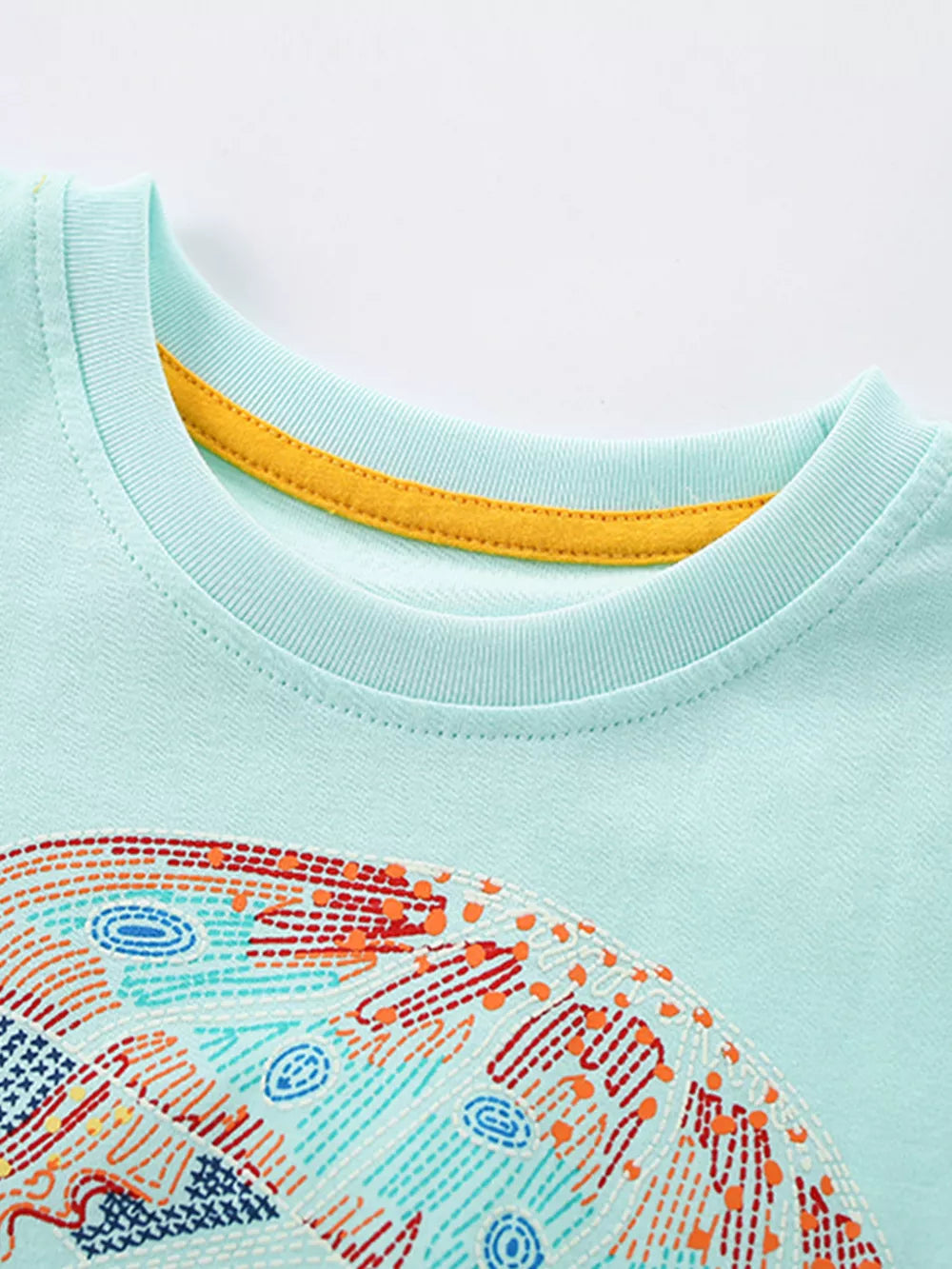 Light blue cotton toddler t-shirt with colorful jellyfish graphic and yellow neck trim.