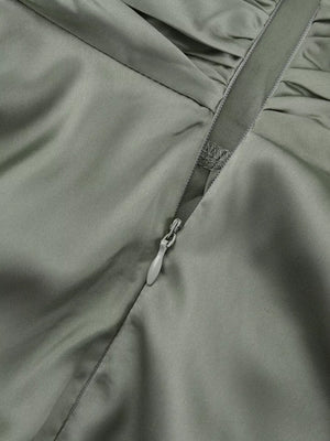 Satin dress in sage green with ruched detail and side zipper.