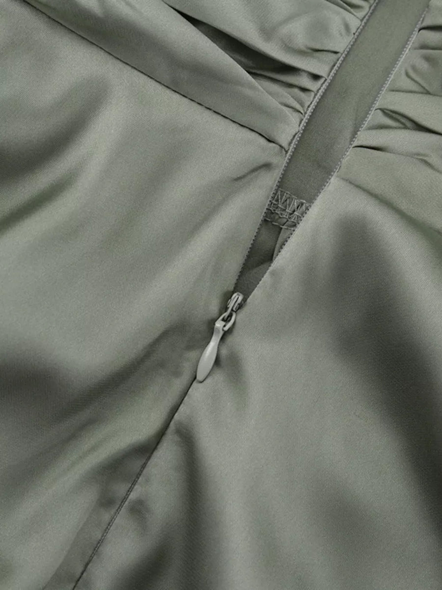 Satin dress in sage green with ruched detail and side zipper.