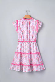 Floral tiered ruffle dress with bouquet print, elastic waist, and pink trim.