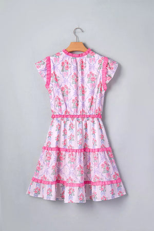 Floral tiered ruffle dress with bouquet print, elastic waist, and pink trim.