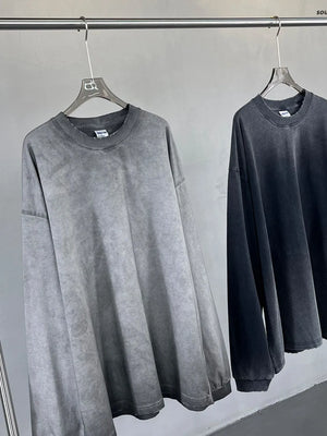 Vintage wash oversized crewneck sweatshirt in gray and black, featuring a distressed look and relaxed fit.