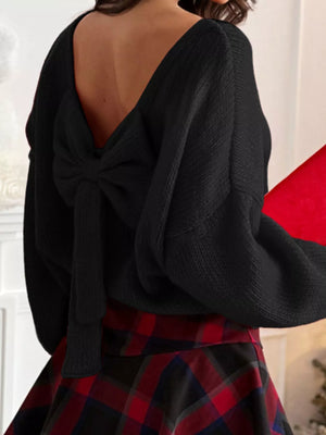 Black long-sleeve sweater with a V-back and a large bow detail.