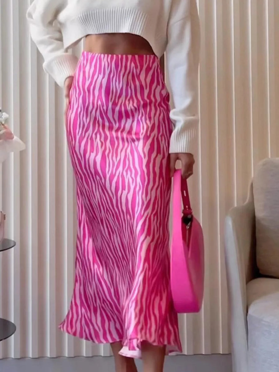 Satin midi skirt with pink and white zebra print, high waist, and slight flare hem.
