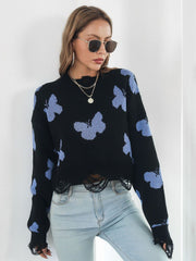 Black cropped knit sweater with distressed butterfly print and frayed hem.