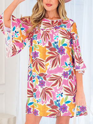 Print bell sleeve mini dress with colorful floral and leaf pattern, white pom trim.