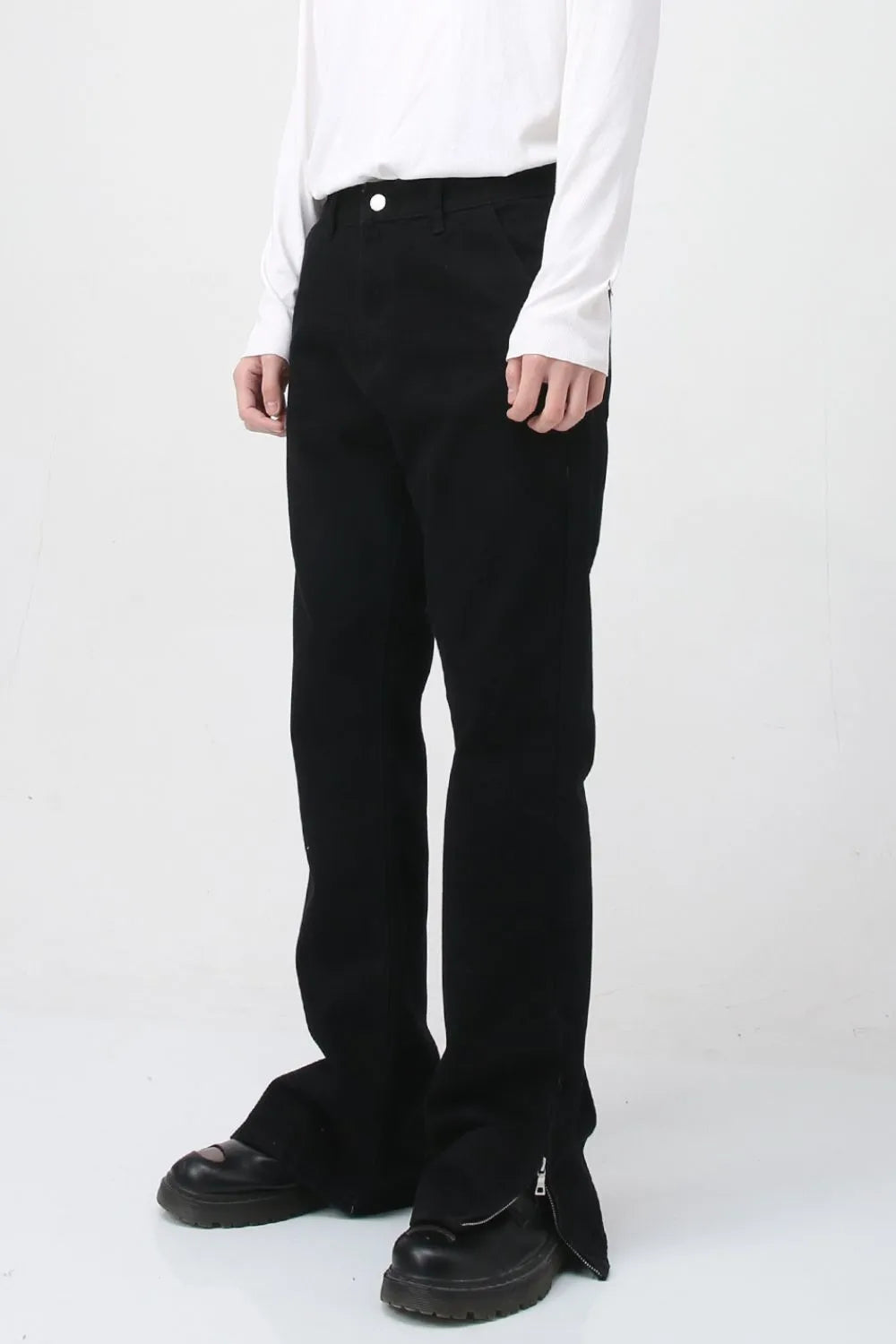 Flared hem denim trousers in dark cotton with zip detail at the ankle.