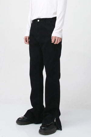 Flared hem denim trousers in dark cotton with zip detail at the ankle.