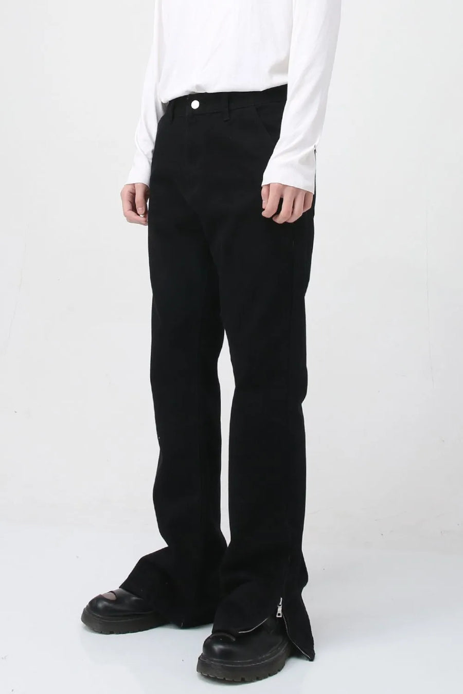 Flared hem denim trousers in dark cotton with zip detail at the ankle.