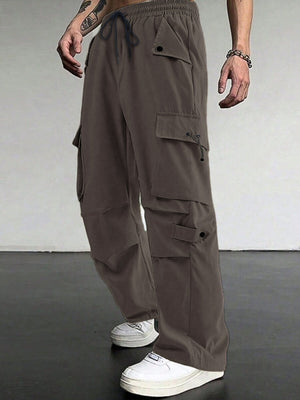 Brown cargo pants with multiple pockets and drawstring waist, styled with white sneakers.