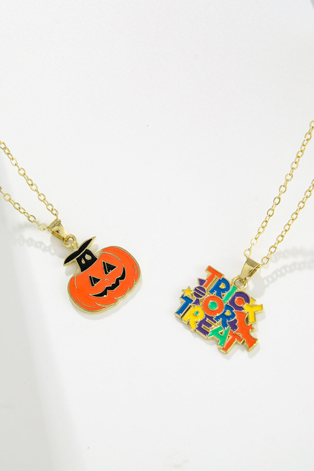 Spooky Season enamel pendant necklaces featuring a jack-o-lantern and "Trick or Treat" text.