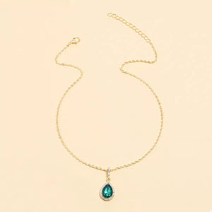 Elegant teardrop pendant necklace in dark green with 18K gold-plated chain and crystal accents.