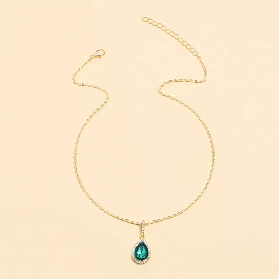 Elegant teardrop pendant necklace in dark green with 18K gold-plated chain and crystal accents.