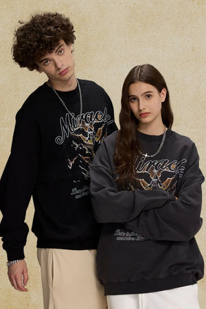 Black and dark gray oversized sweatshirts with "Miracle" graphic and text detail.