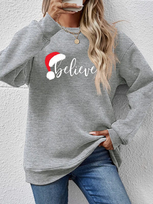 Gray raglan sweatshirt with "Believe" and Santa hat graphic, crew neck, long sleeves.