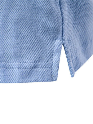 Light blue textured polo shirt detail showing side vent and stitching