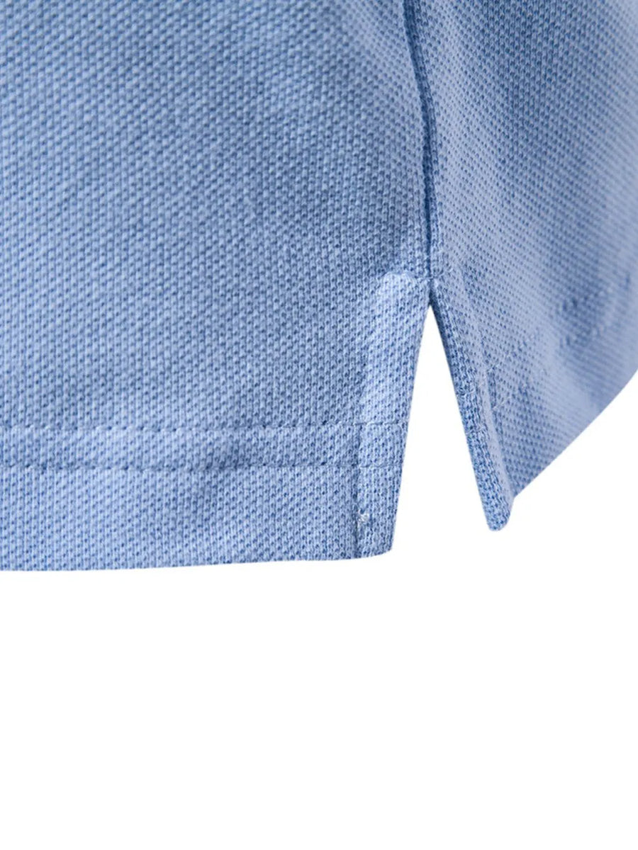 Light blue textured polo shirt detail showing side vent and stitching