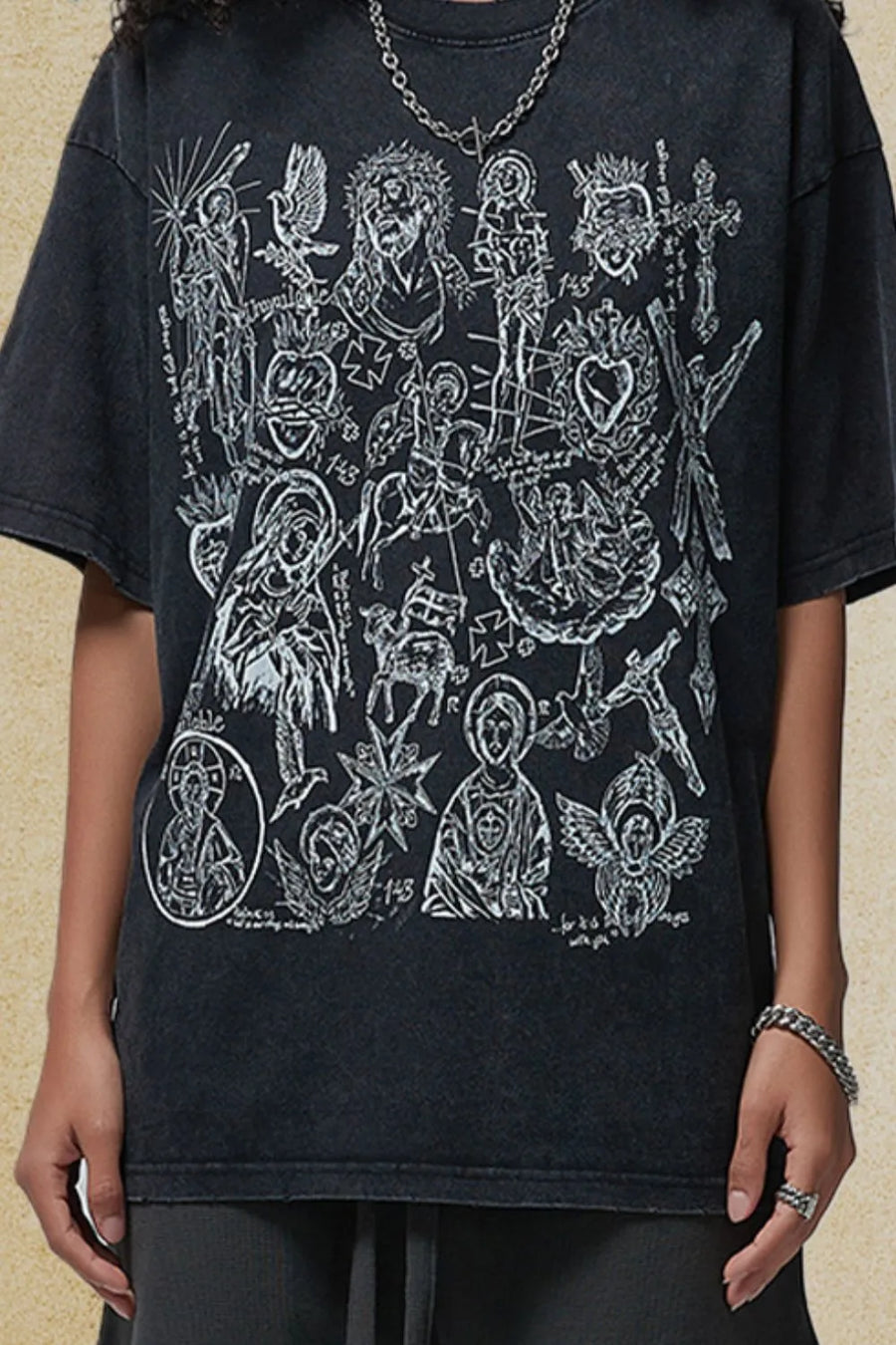 Black vintage wash t-shirt with religious icon graphic print.
