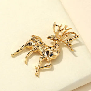 Gold geometric stag brooch made of alloy with faceted details.