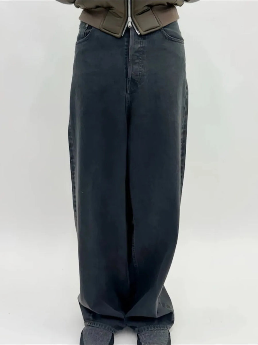 Baggy dark wash denim jeans with a sculpted hemline and a casual fit.