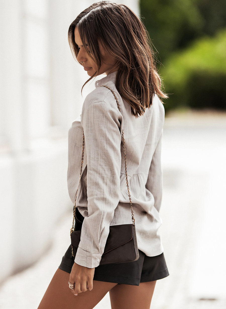 Light Gray textured cotton relaxed fit shirt with buttoned cuffs and a cinched waist detail.