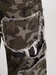 Star-embellished distressed wide-leg jeans in camouflage print with frayed edges.