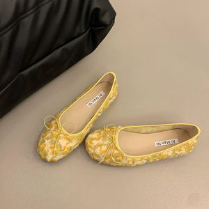 Yellow floral bow slip-on flats with 3D texture and a comfortable casual style.