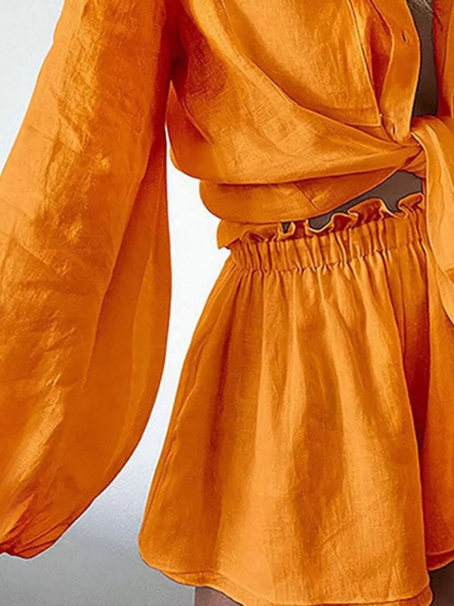 Tangerine relaxed two-piece shirt and shorts set with ruffled waist shorts and tie-front shirt.