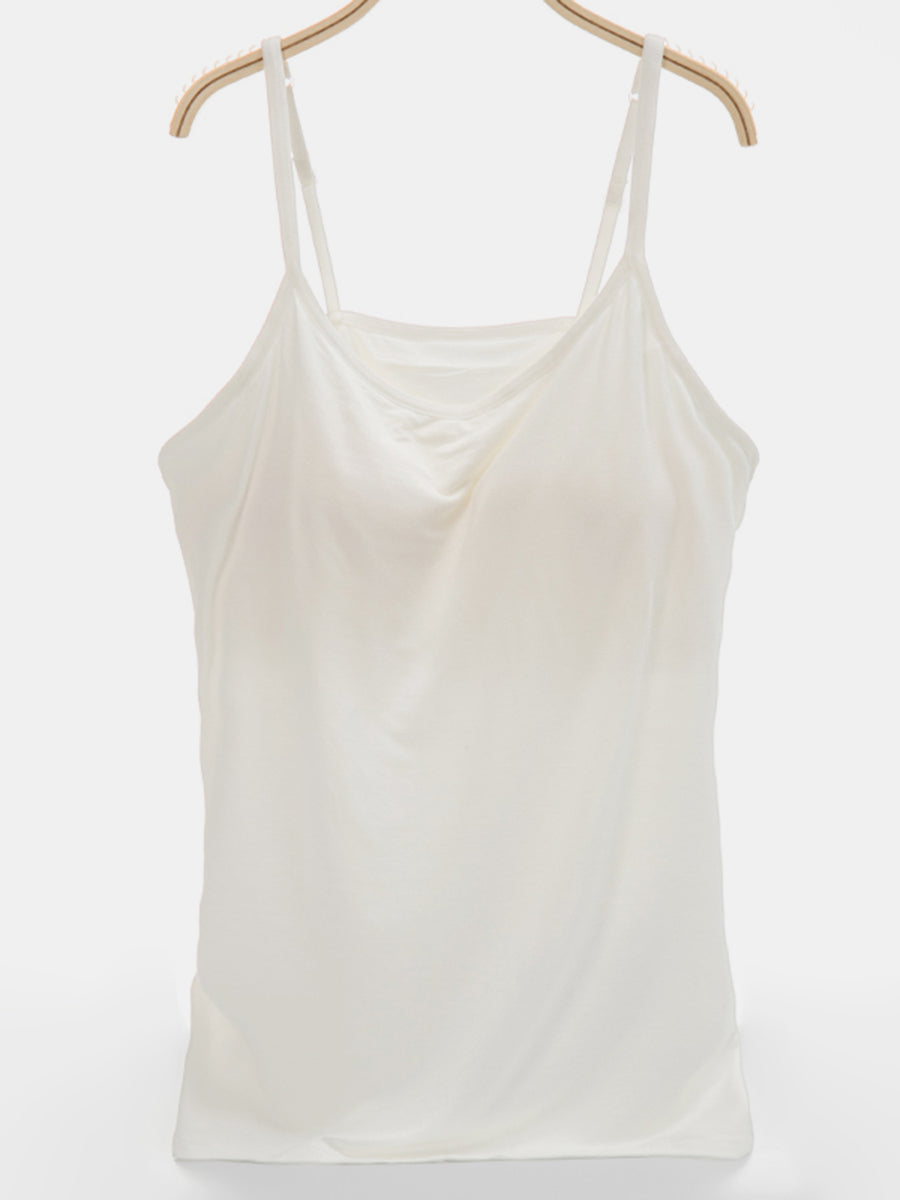 Ivory soft-cup cami with adjustable straps and a draped neckline.