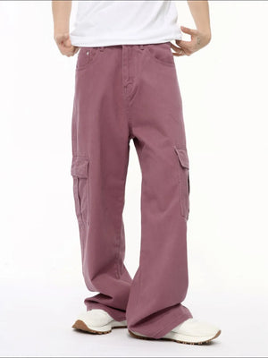 Oversized cargo denim trousers in dusty pink with multiple pockets and a relaxed fit.