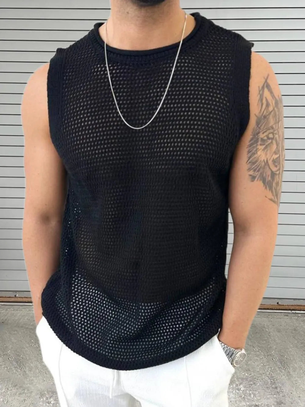 Black open-knit sleeveless crewneck tank top with a sheer, mesh texture.