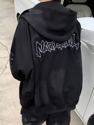 Black oversized zip-up hoodie with graphic detail on back and sleeve