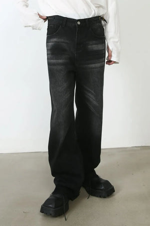 Dark wash denim barrel leg jeans with cat's whisker detailing and a relaxed fit.