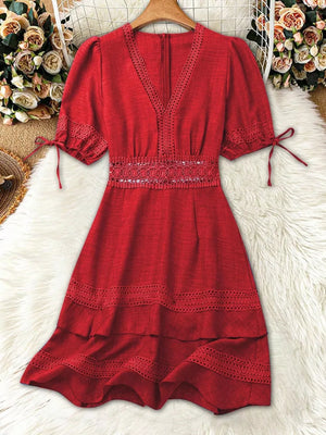 Red lace-embellished V-neck mini dress with tie-sleeve detail and tiered hem.