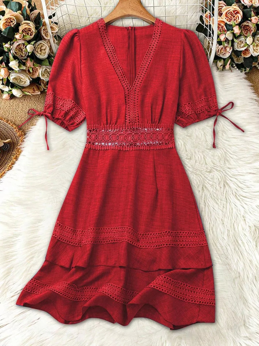 Red lace-embellished V-neck mini dress with tie-sleeve detail and tiered hem.