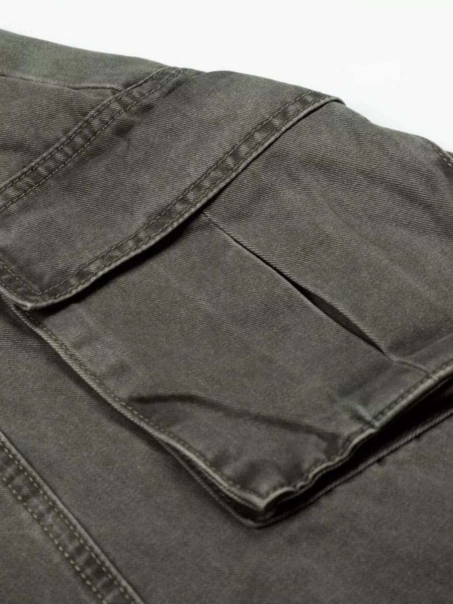 Green wide-leg cargo pants with visible stitching and large flap pockets.